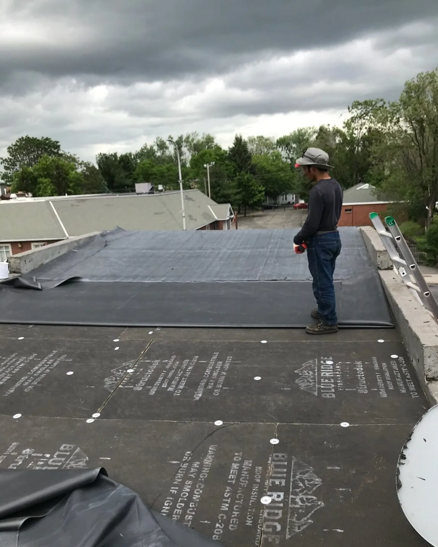 ART ROOFING estimator walking storm damage with an insurance adjuster on a roof