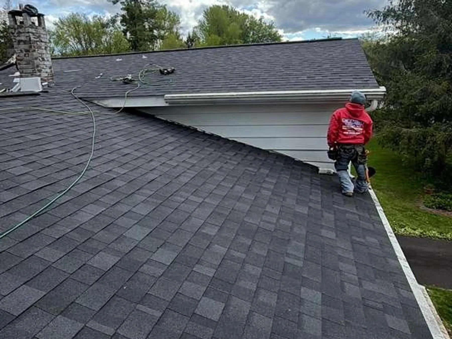 Seamless gutter run with a guard system and hidden hangers