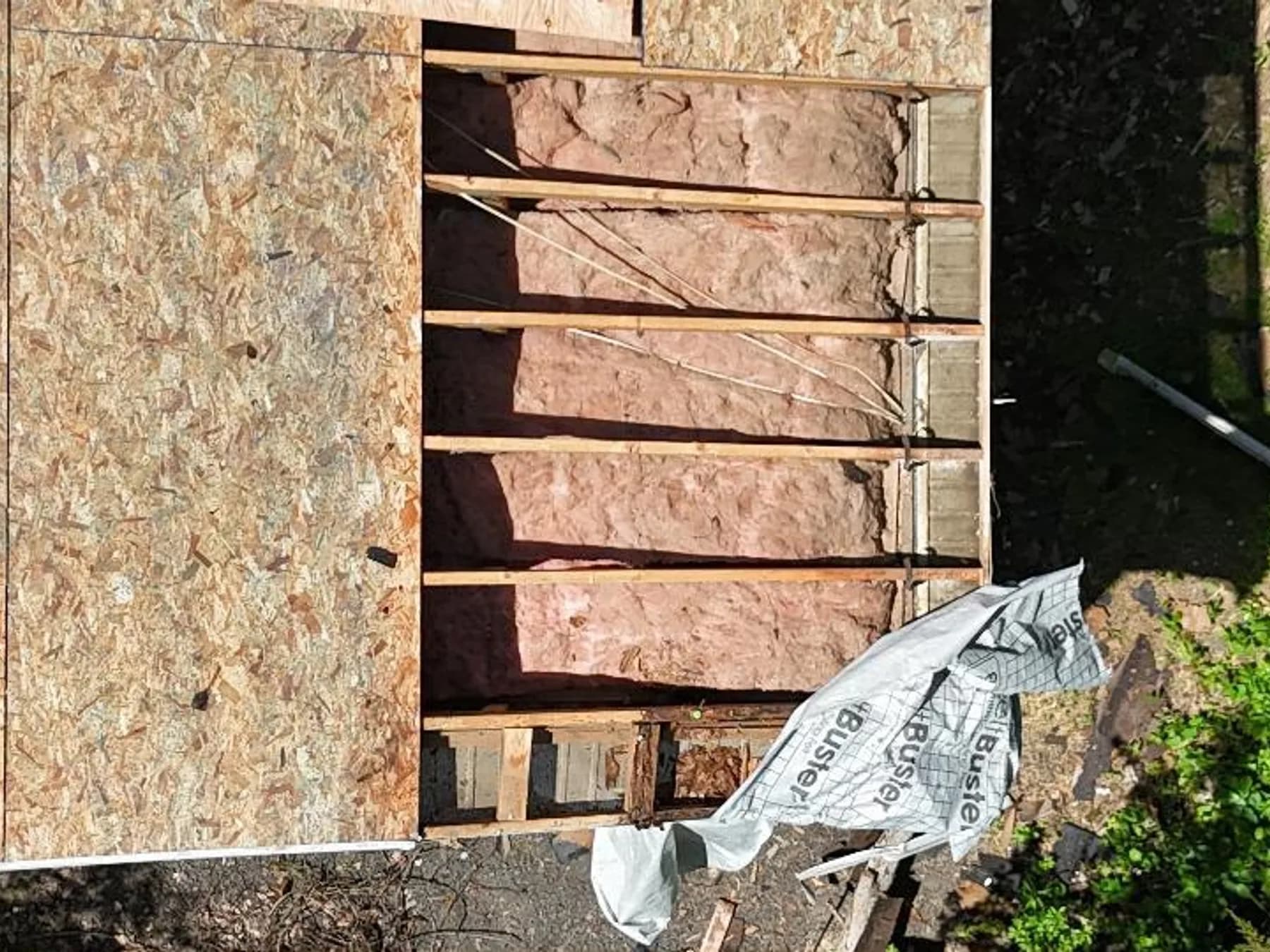 Roofer checking vent boots and sealant during a seasonal inspection