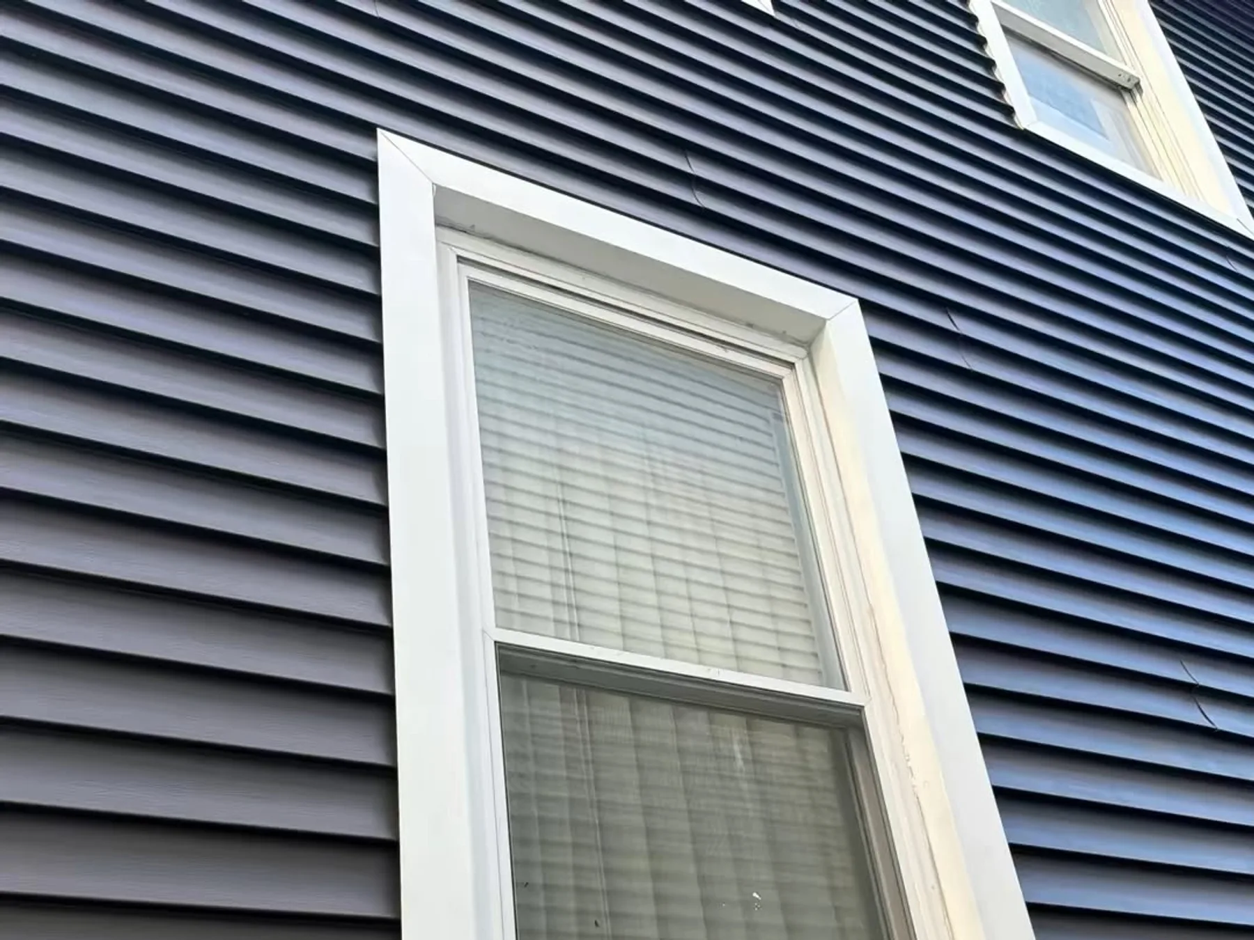 Fiber cement siding and trim detail on a residential wall
