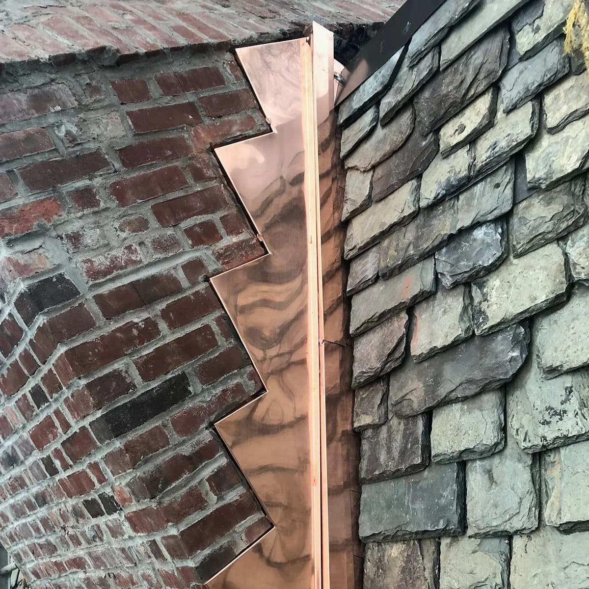 Close detail of shingle and flashing work