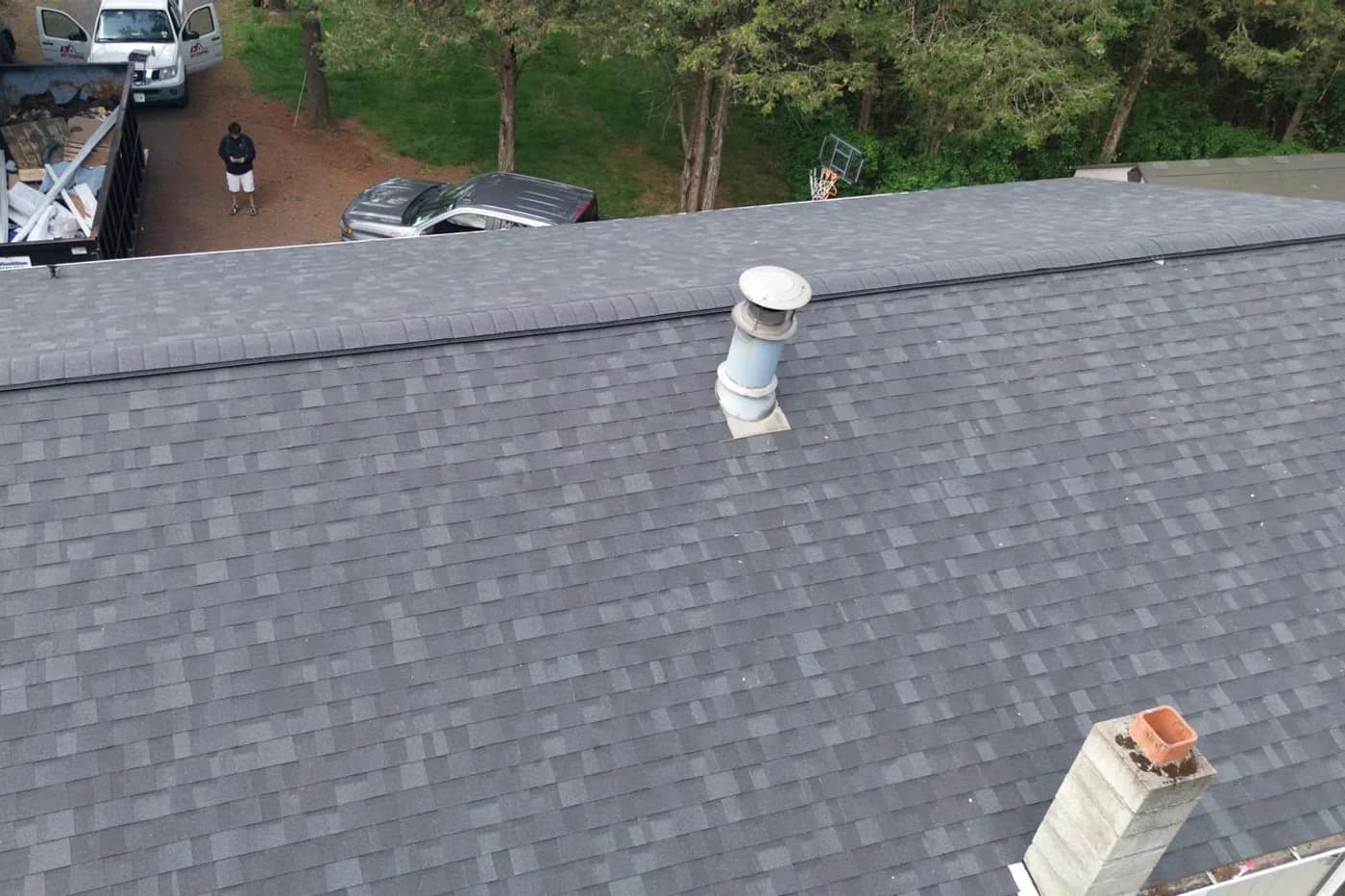 Seamless gutter and downspout installed along a roofline