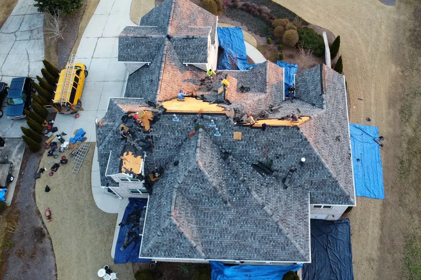 Roofer photographing storm damage for an insurance claim
