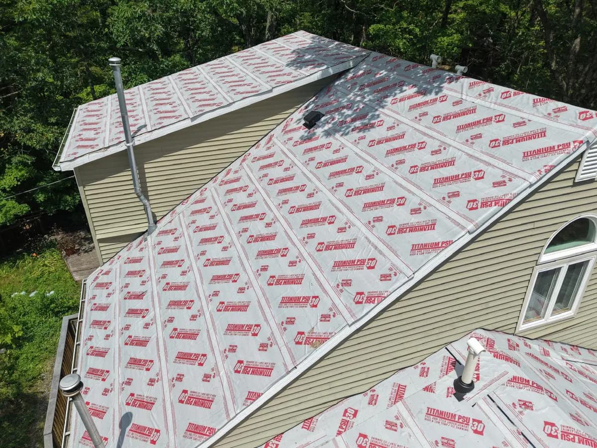 Close view of charcoal lap siding meeting a white-framed window