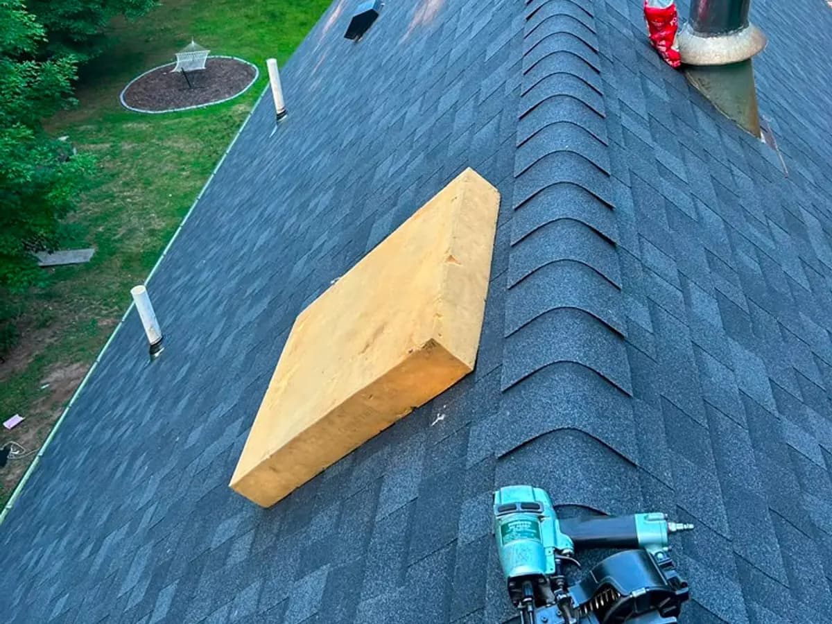 Roof opened up during tear-off showing rotted decking boards underneath