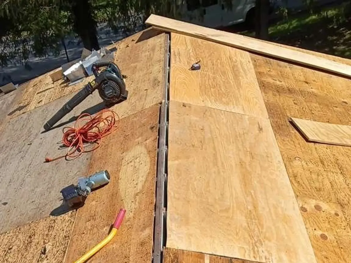 Damaged roof section stripped to the rafters before rebuilding