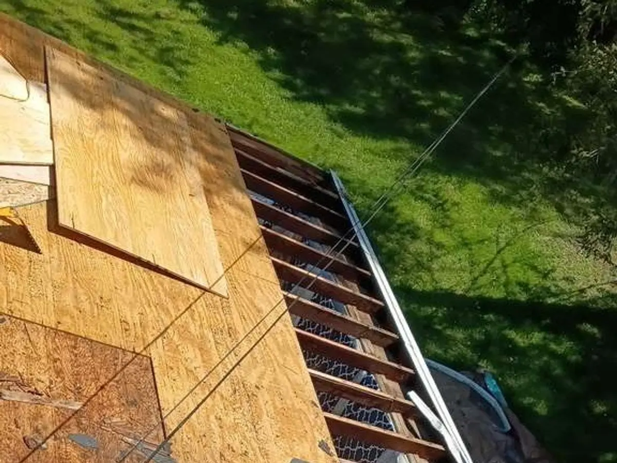 Roof deck exposed and re-sheathed with new plywood after storm damage